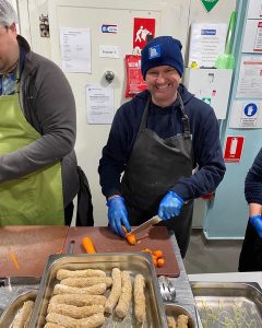 Jake preparing food to feed people experiencing homelessness